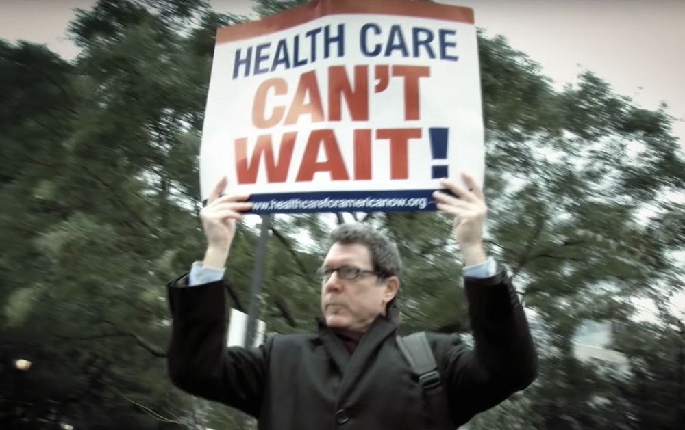 man holding sign above head